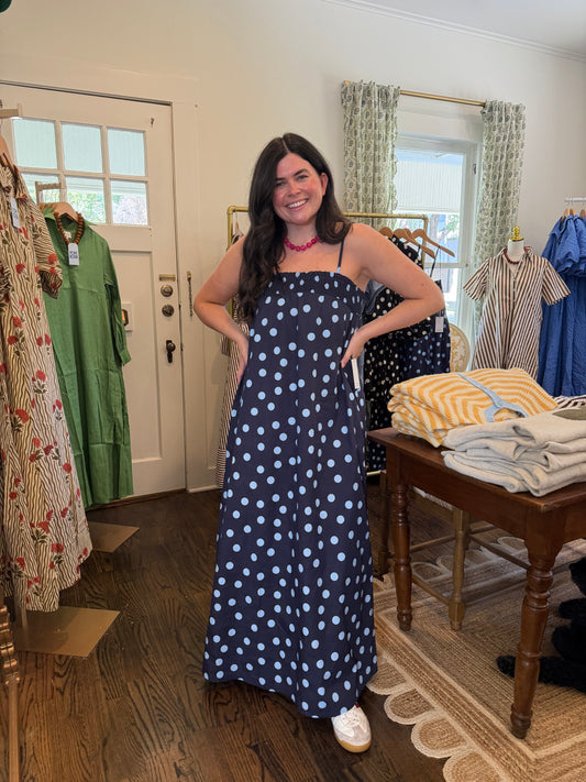 Model wearing the Navy Polka Dot Maxi with sneakers, full length in the shop