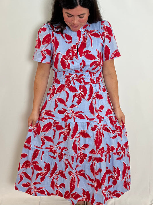 Model wearing the Printed Midi Dress, light blue with a red leaf print, front view