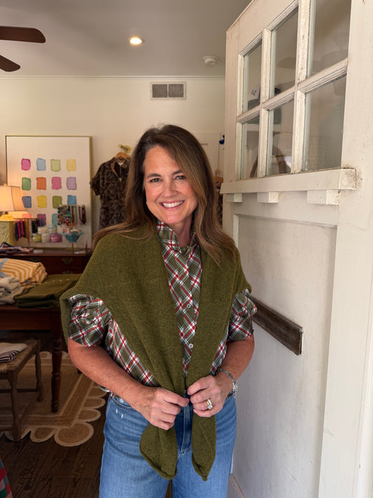 Model wearing the Mossy Green Cardigan over her shoulders with a plaid blouse