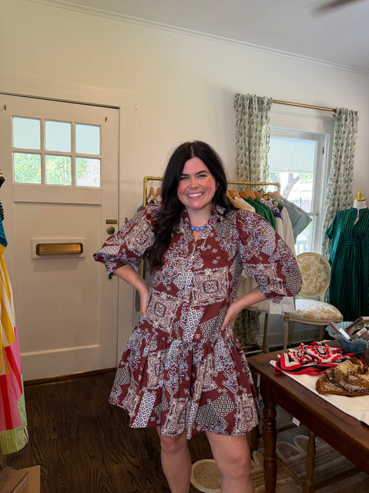 Model wearing the Maroon Bandana Mini Dress, hands on hips, full length in the shop