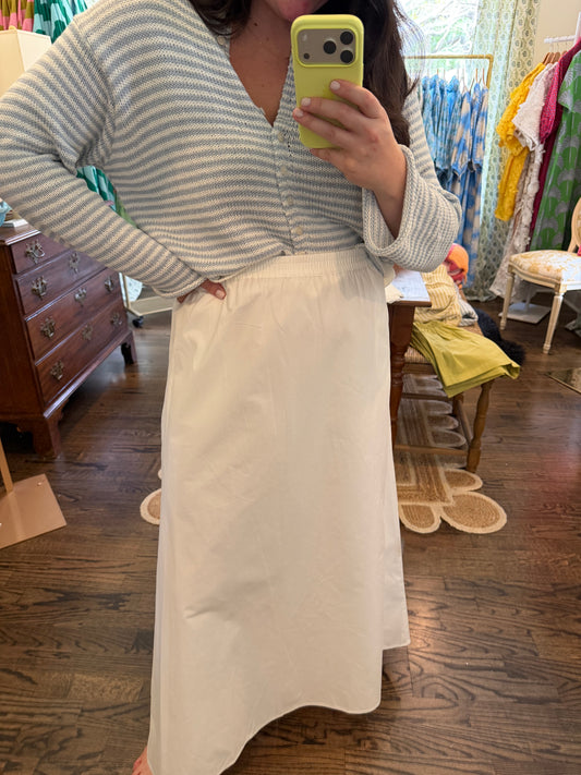 Model taking a mirror photo in the White Sands Skirt, a white maxi skirt, with a gray stripe sweater