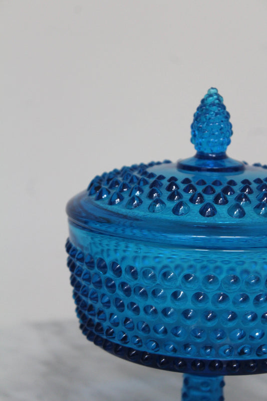 Close view of the blue hobnail compote's raised dots and pointed lid knob