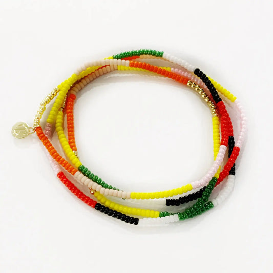 Montego seed bead bracelets in red, orange, yellow, green and black laid flat on white