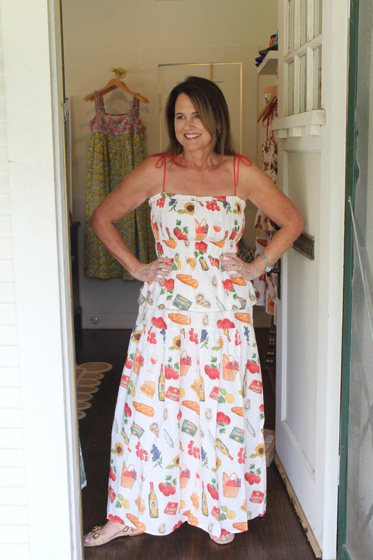 Model wearing the Spritz Top with the matching Spritz Skirt, full length in a doorway
