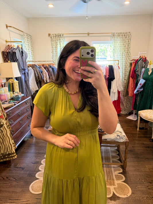 Model taking a mirror photo in the Chartreuse Midi, close view of the V neck and tiers