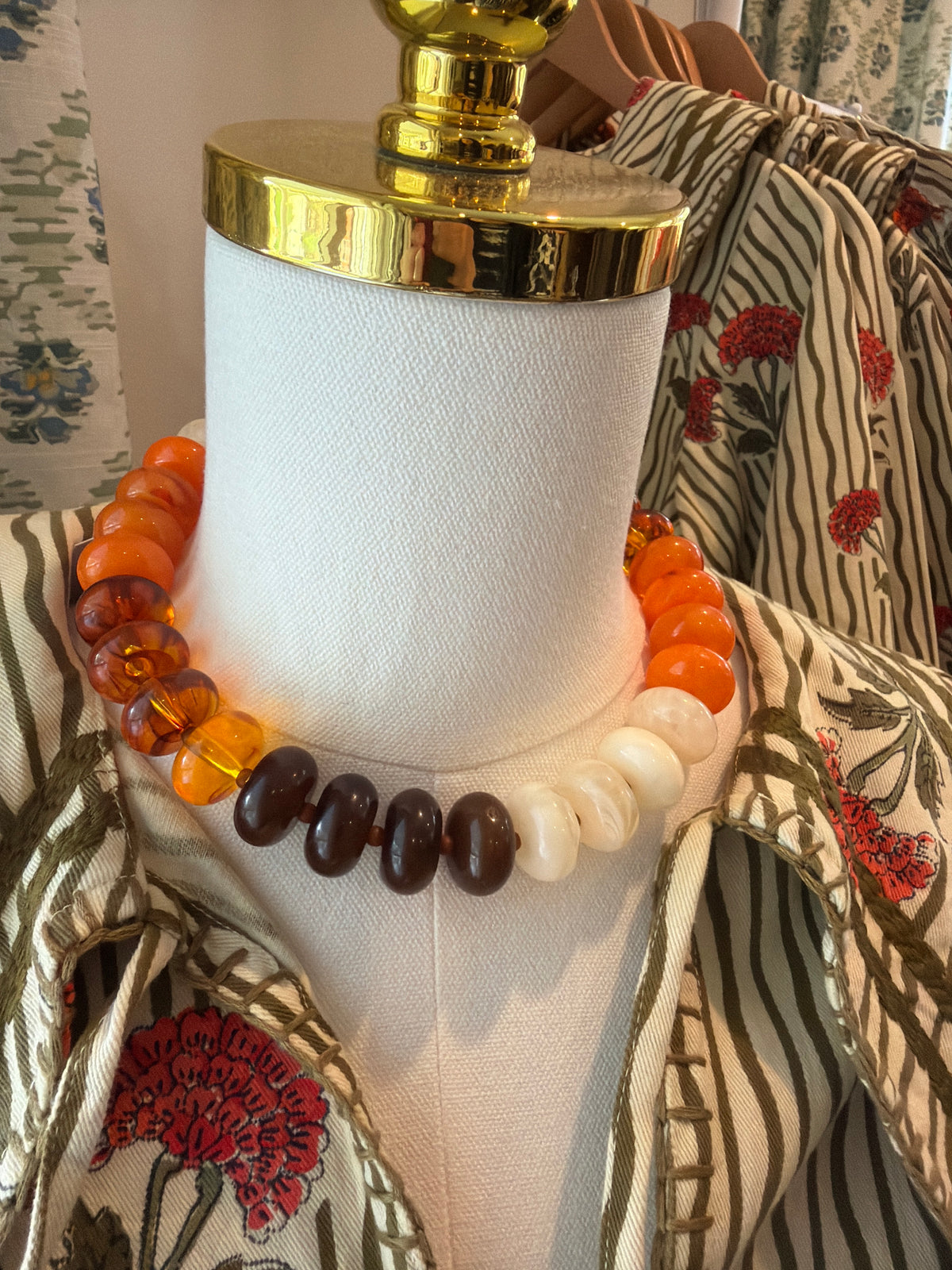 Fall Multicolor Bubble Necklace in orange, amber, cream and brown beads on a dress form