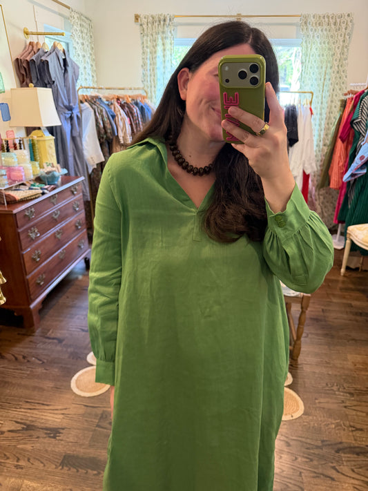 Model taking a close mirror photo in the Green Linen Midi, showing the split collar and long sleeves