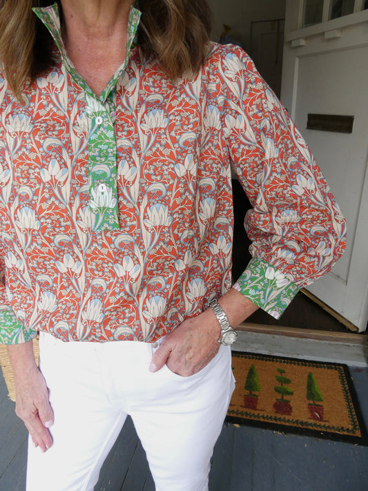 Close view of the Tulip Top's rust and pink floral print with green trim at the placket