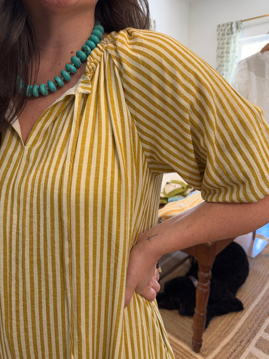 Close view of the Honey Stripe Maxi Dress's yellow and cream stripes and puff sleeve