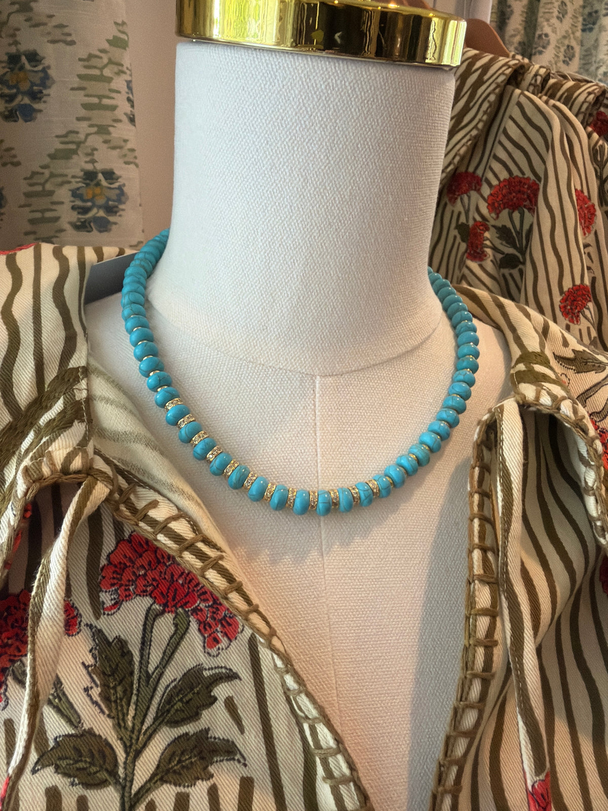 Turquoise Stone Mini Bead Necklace on a dress form over a print shirt