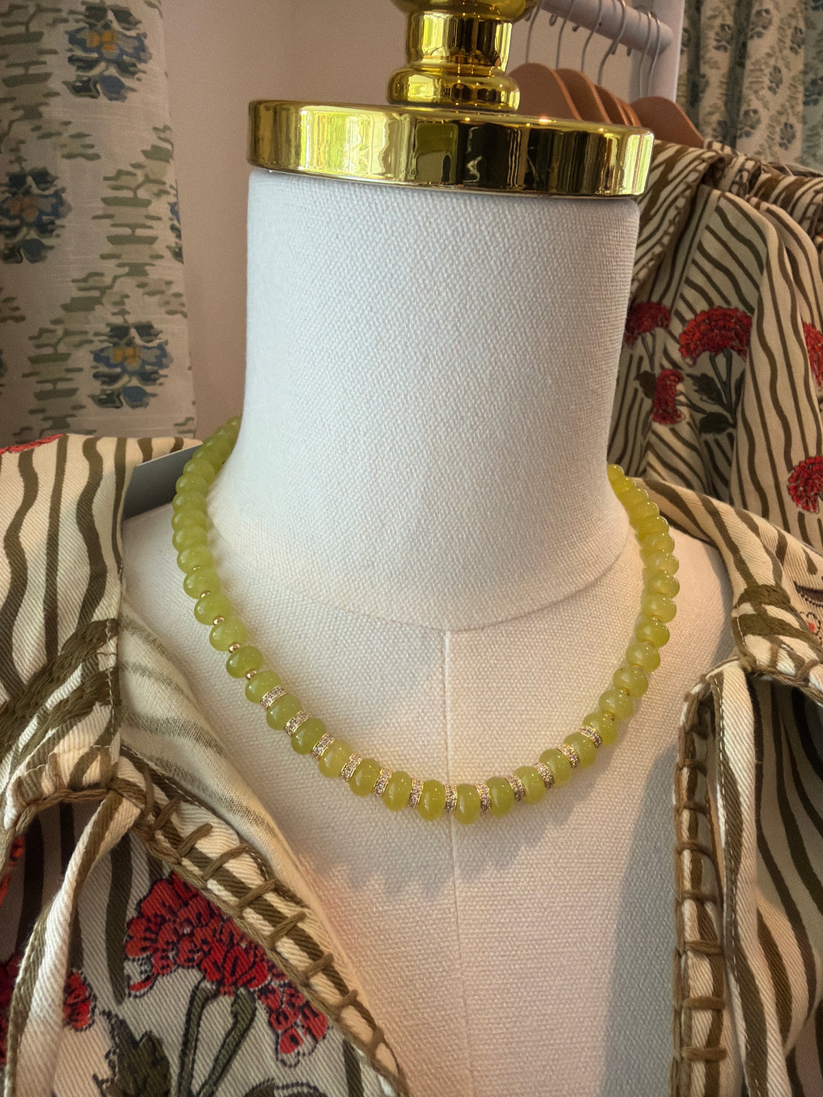 Lime green Stone Mini Bead Necklace on a dress form over a print shirt