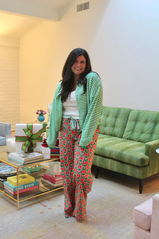 Model wearing the Candy Cane PJ Pants with a green stripe cardigan, full length