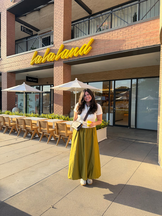 Model wearing the Olive Bubble Skirt with a white tee outdoors on a patio