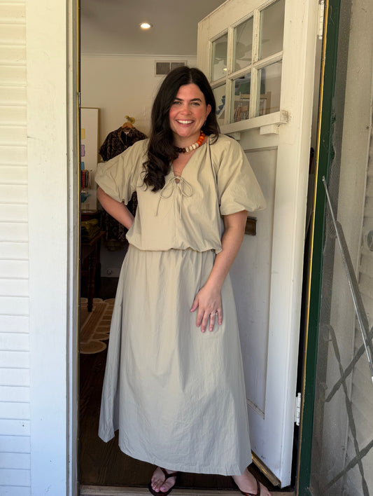 Model wearing the Khaki Bubble Set, a khaki puff sleeve top and maxi skirt
