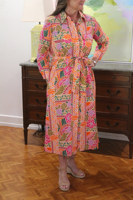 Model wearing the Tropical Shirt Dress, full length view with the tie waist, indoors
