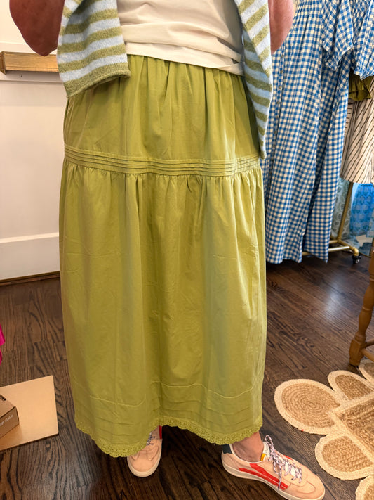 Close view of the Evergreen Midi Skirt's green cotton and stitched tier seams