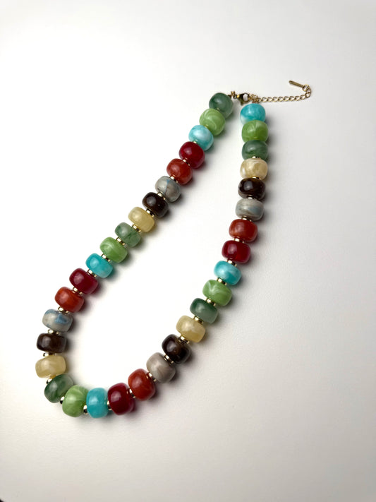 Chunky Fall Necklace with jewel tone beads and gold accents, laid flat
