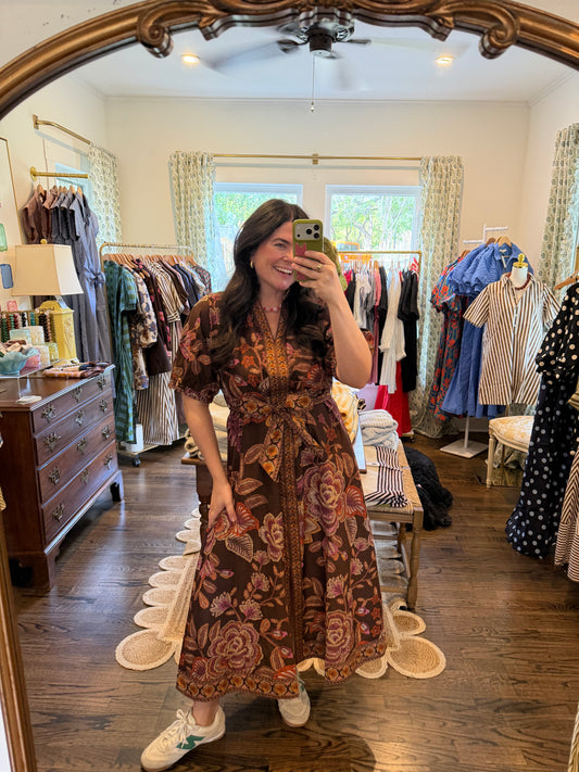 Model taking a mirror photo in the Brown Gimme Color Midi, a brown print midi dress