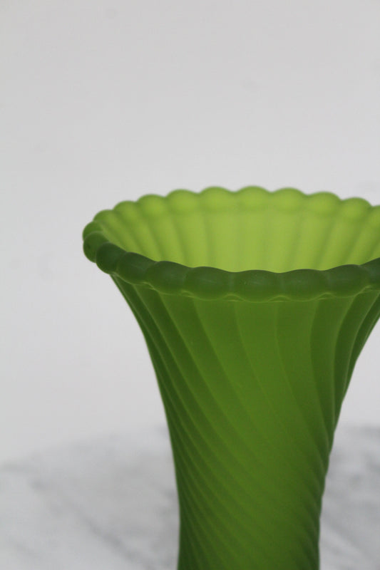 Close view of the frosted green Westmoreland vase's scalloped rim and swirled body